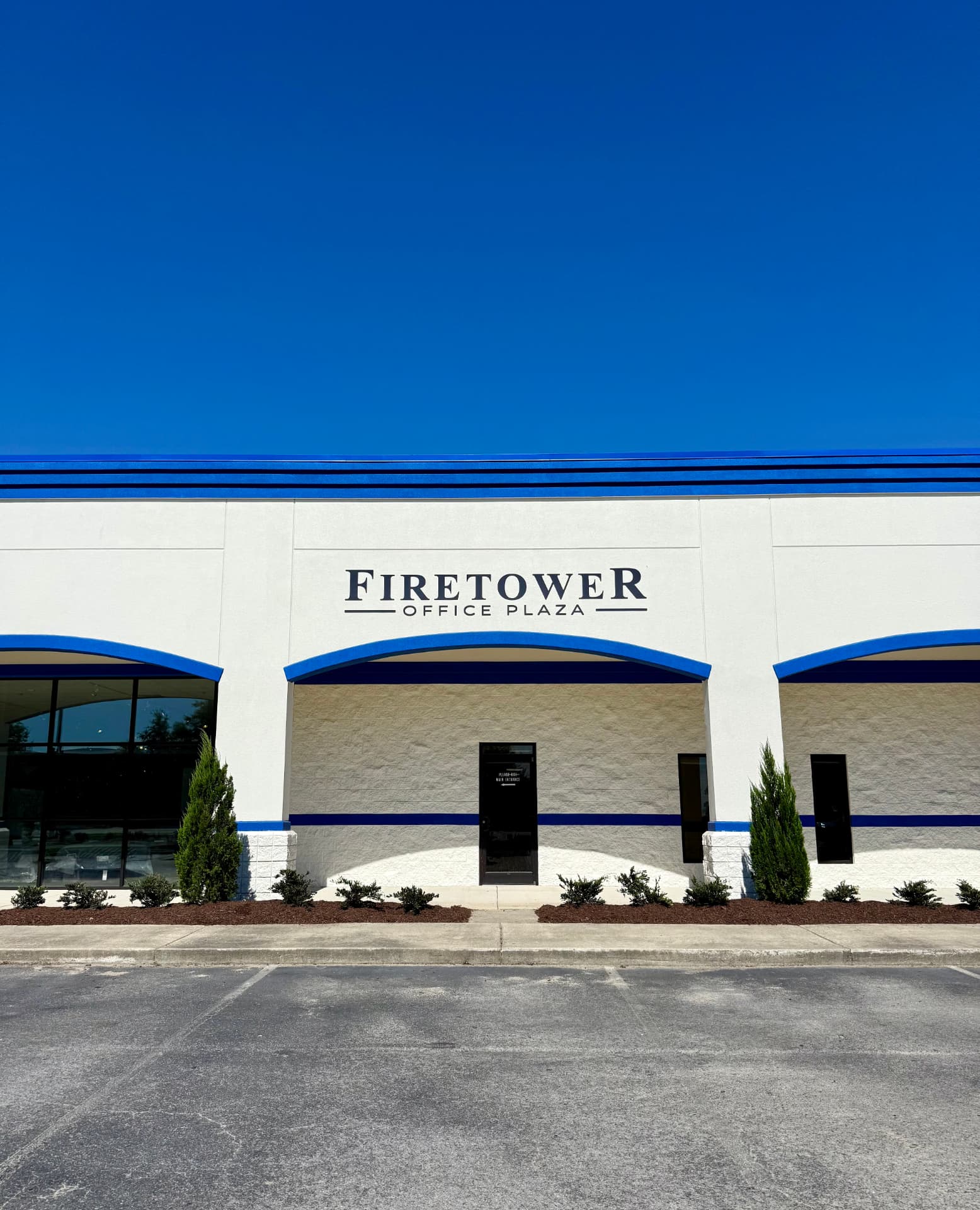 Firetower Office Plaza exterior with blue awnings in Greenville